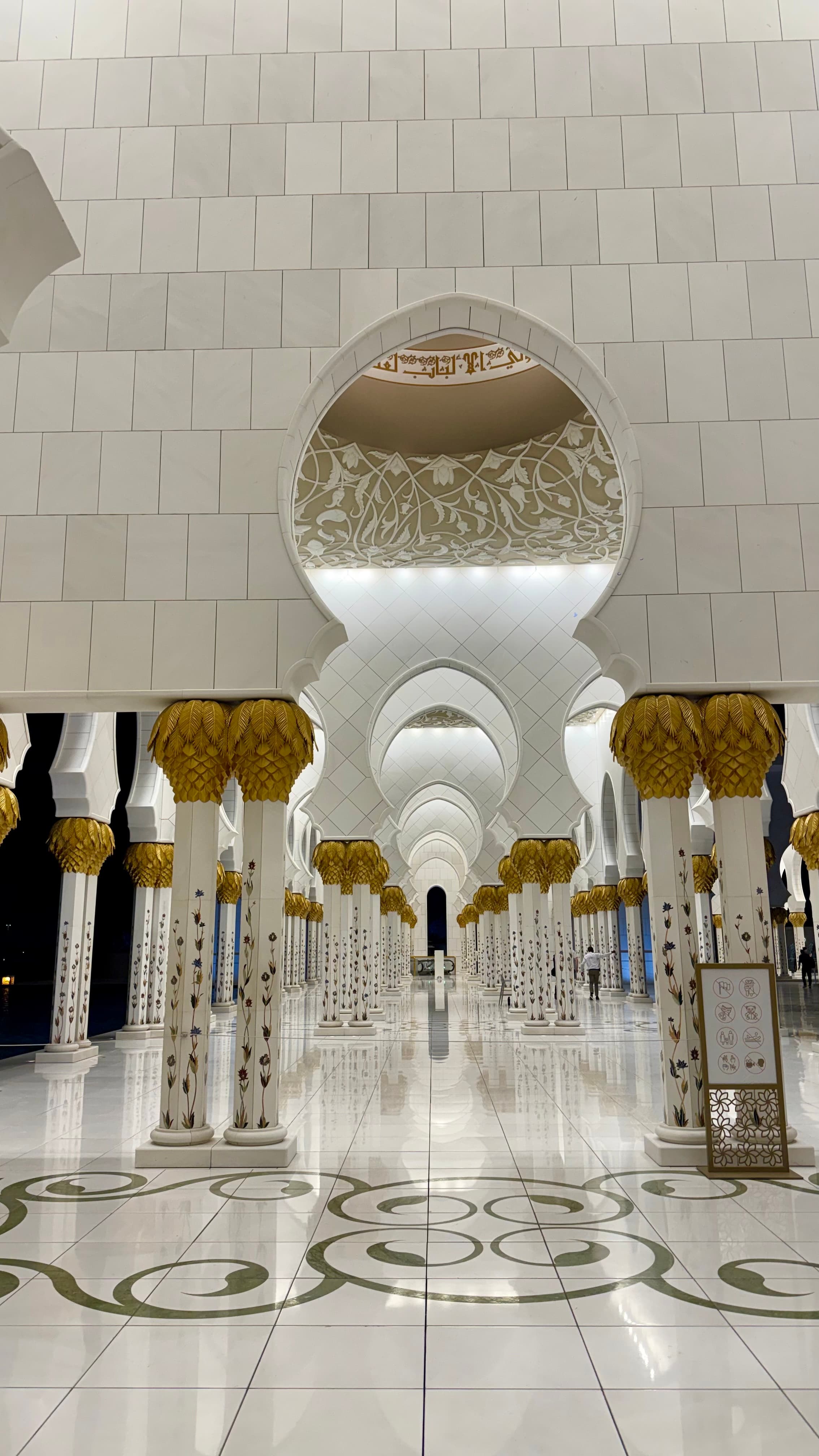 The arched colonnade and inlaid floral marble of the Sheikh Zayed Grand Mosque courtyard, Abu Dhabi