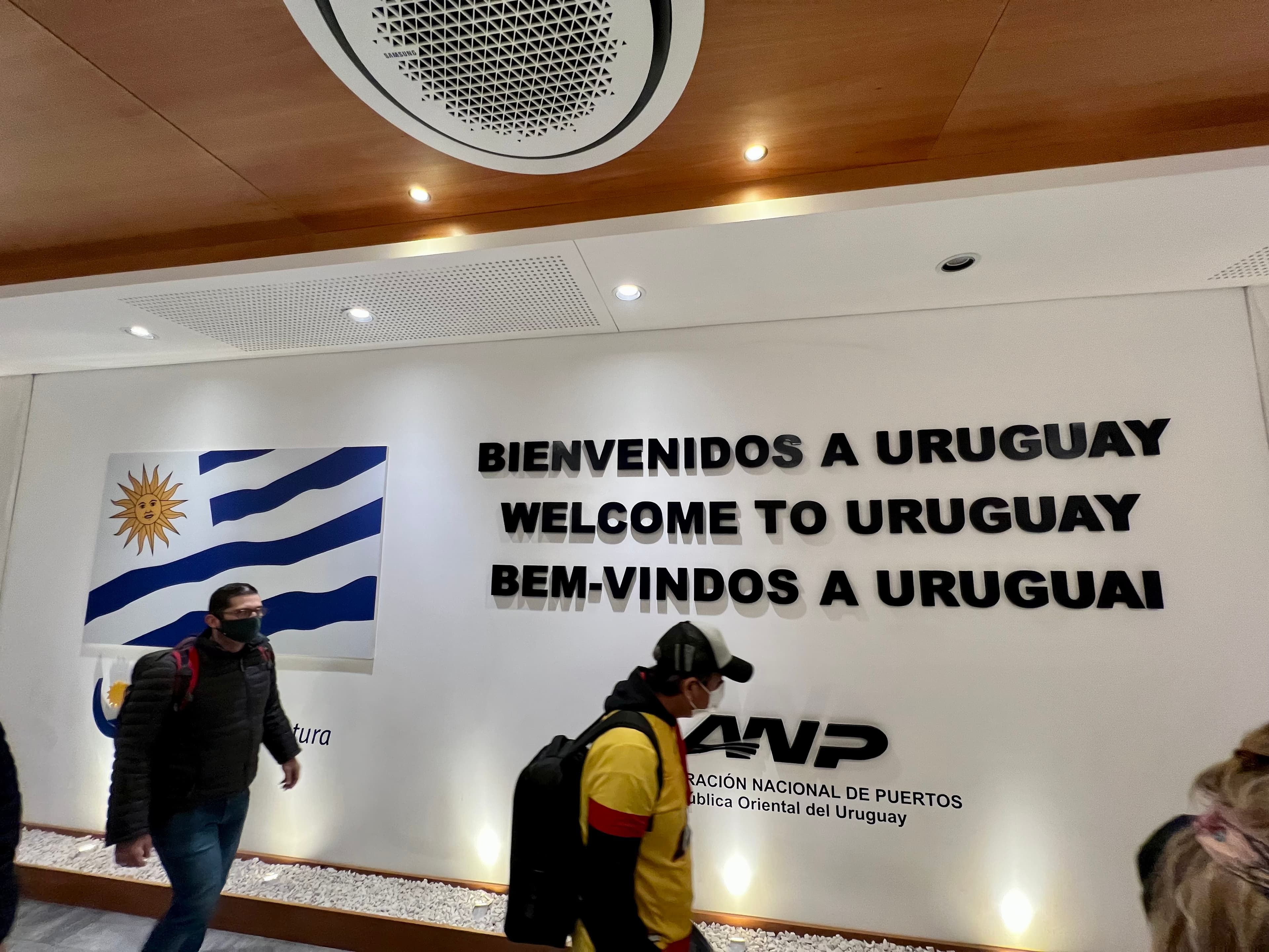 Welcome to Uruguay sign and the Uruguayan flag in the arrivals hall of the Colonia ferry terminal