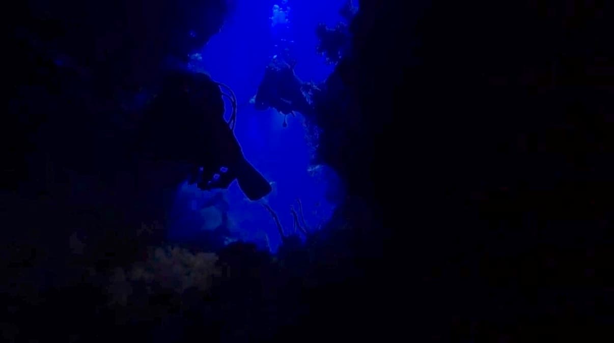 Divers descending the reef at the Police Station dive site off Little Giftun Island, Hurghada