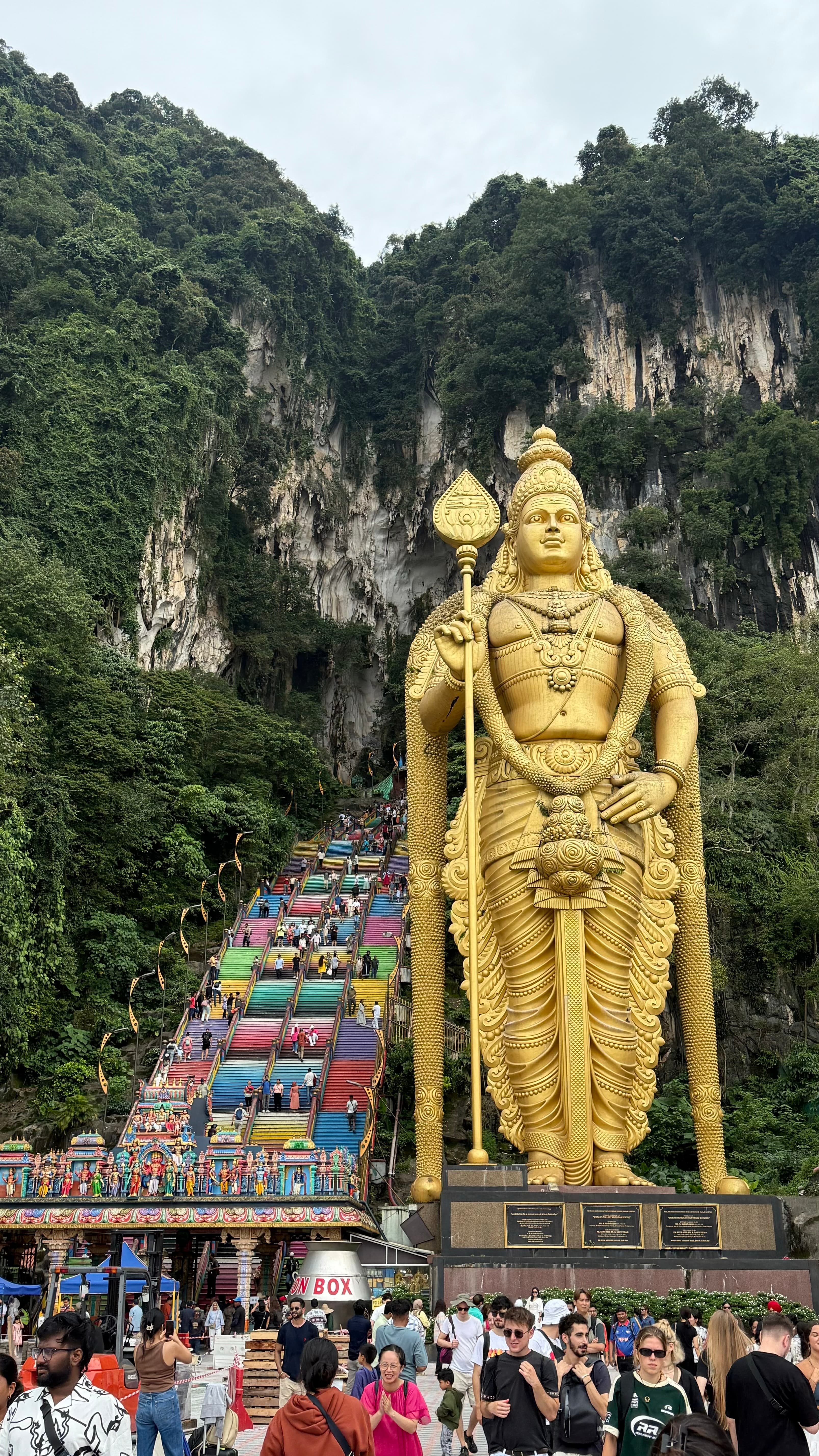 The rainbow steps and golden Lord Murugan statue at Batu Caves near Kuala Lumpur