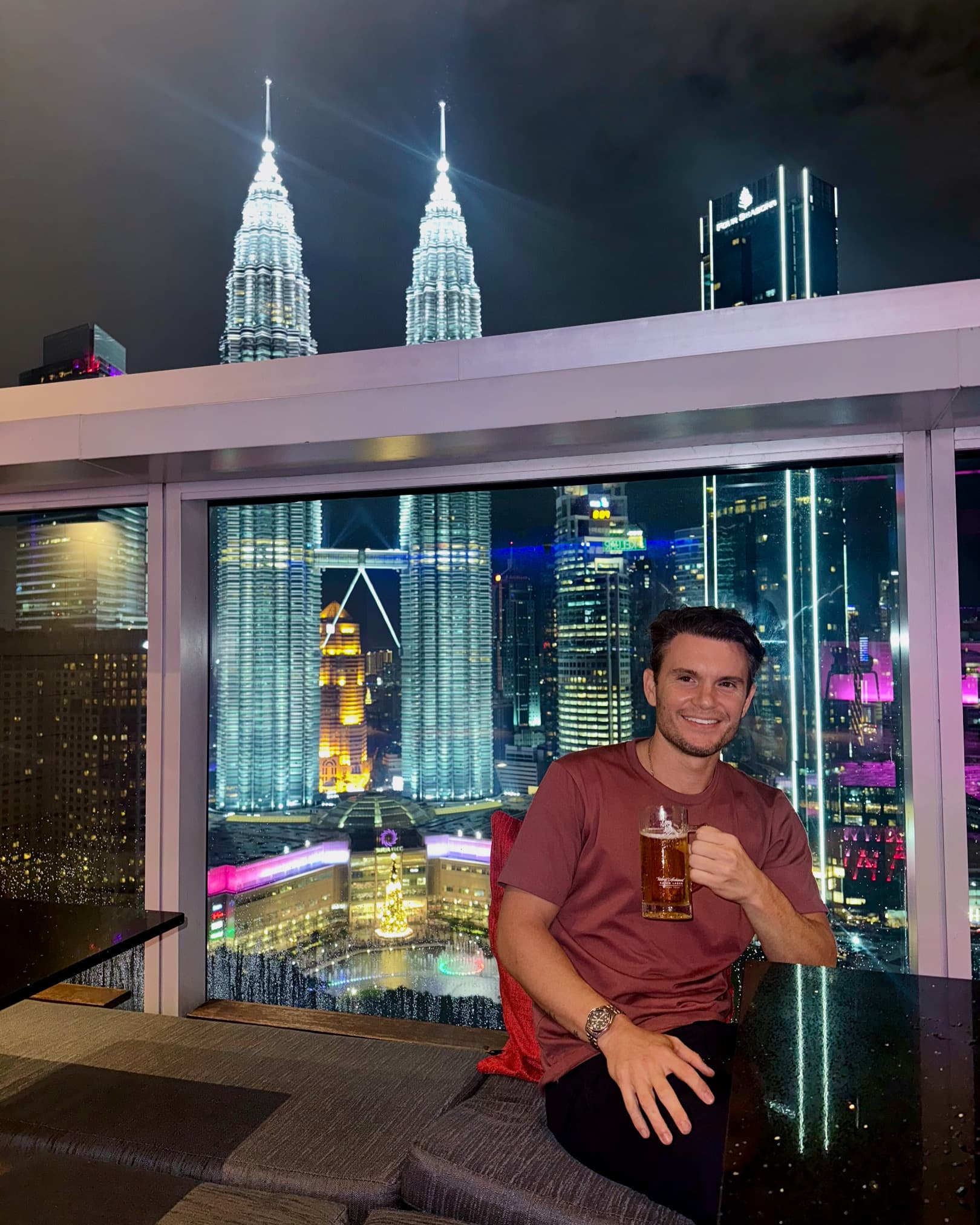 A beer at a rooftop bar overlooking the Kuala Lumpur skyline