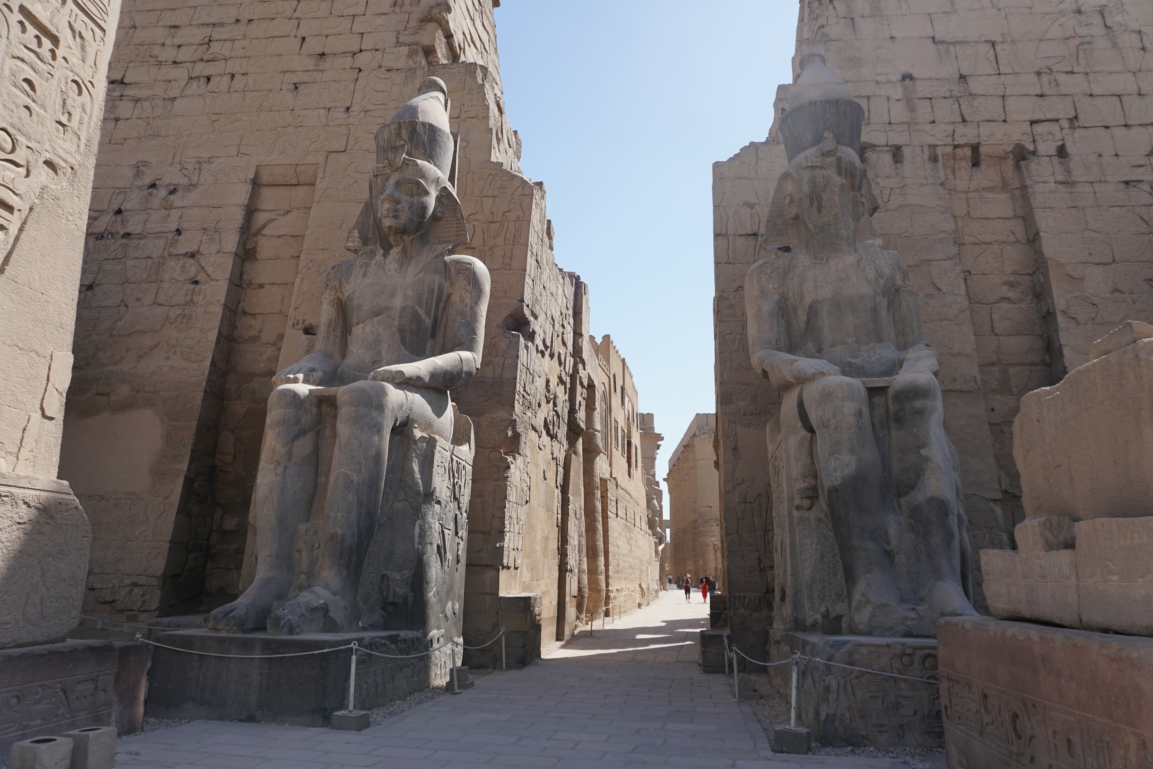 Colossal pharaonic statues flanking the entrance to Luxor Temple