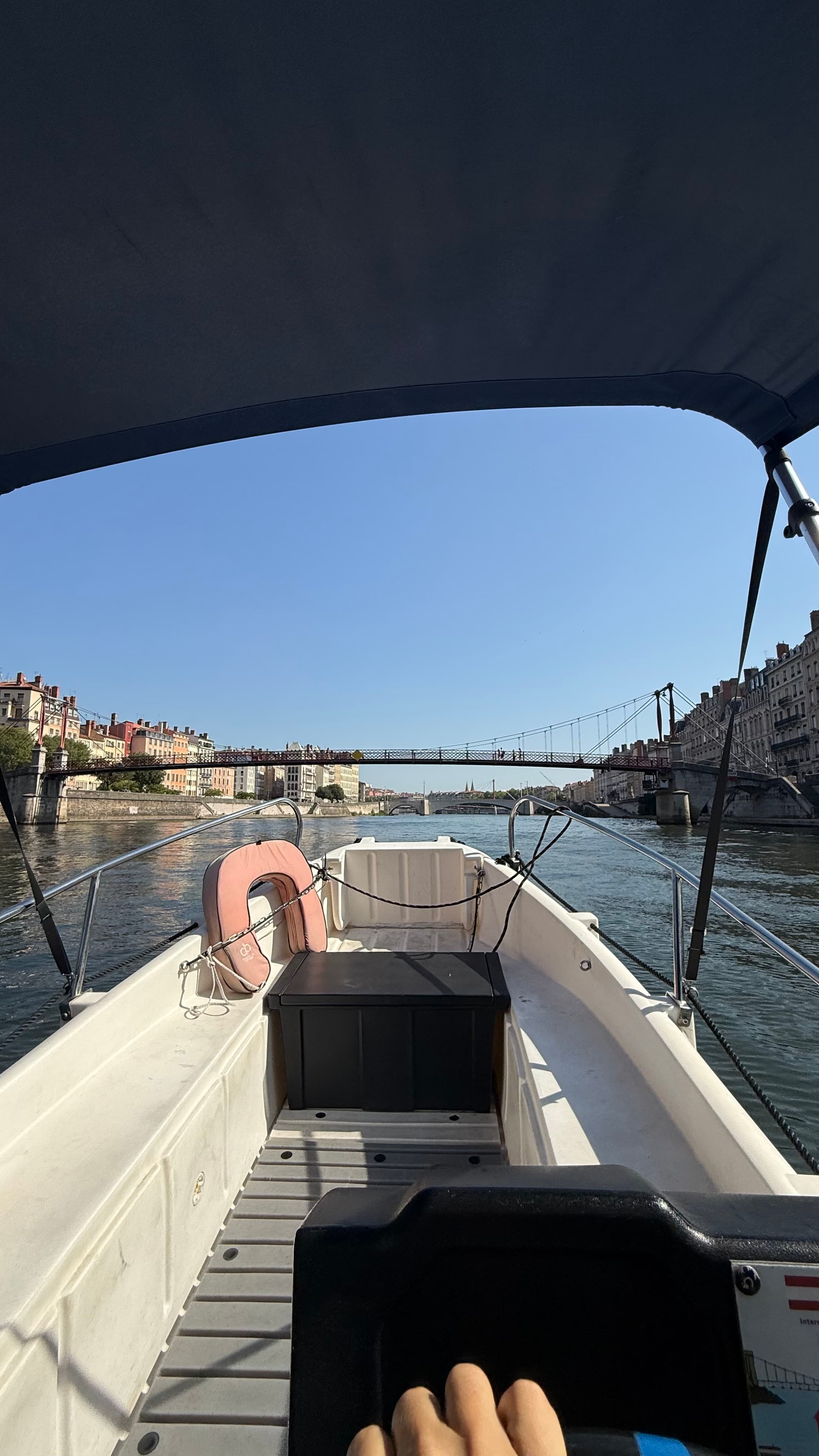 A small boat on the Saone river below the old town of Lyon