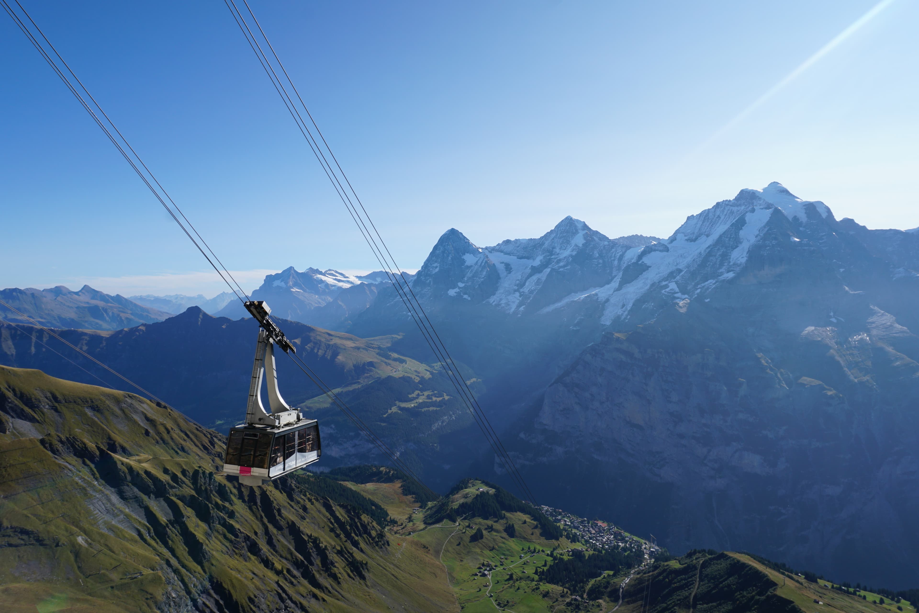 A cable car gondola climbing above the valley in the Jungfrau region, Switzerland