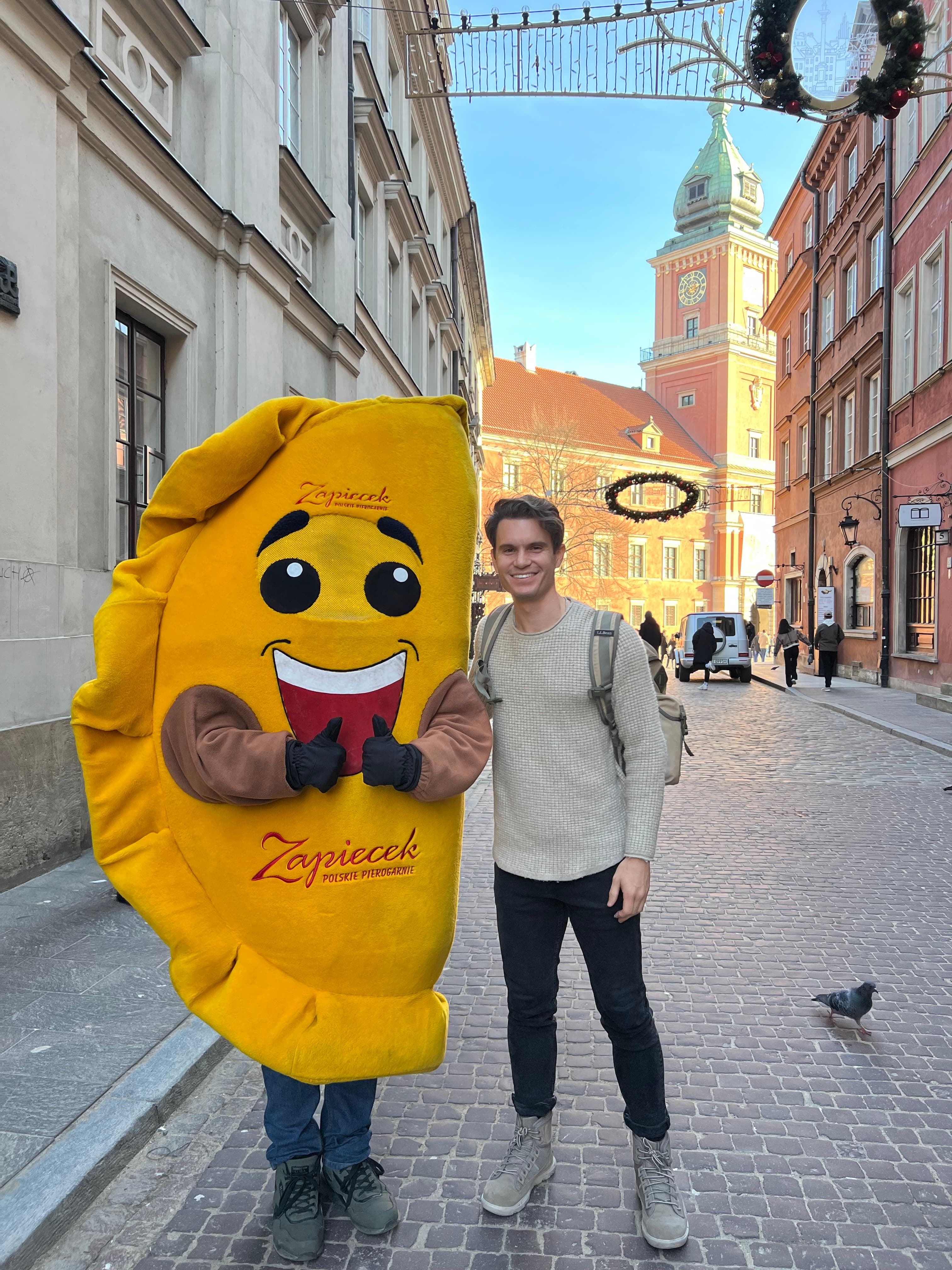 A costumed pierogi mascot on a street in Warsaw