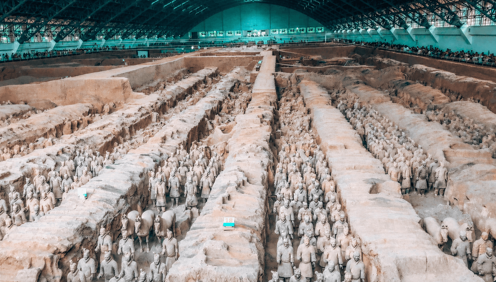 Rows of the Terracotta Army standing in the excavated trenches of Pit 1 under its hangar roof near Xi'an, China